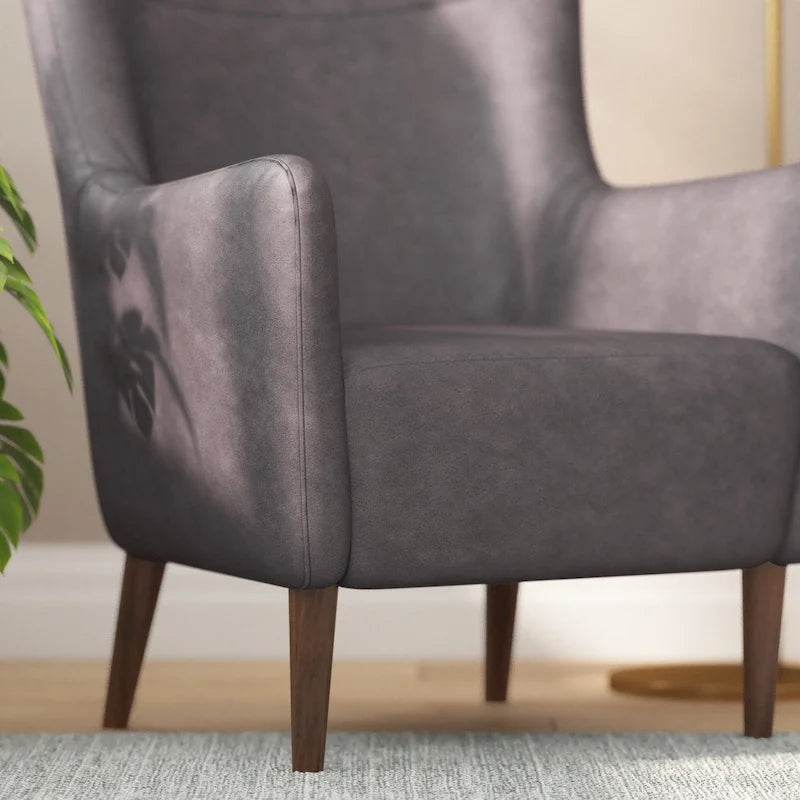 Sillón tapizado de respaldo alto con estructura de madera